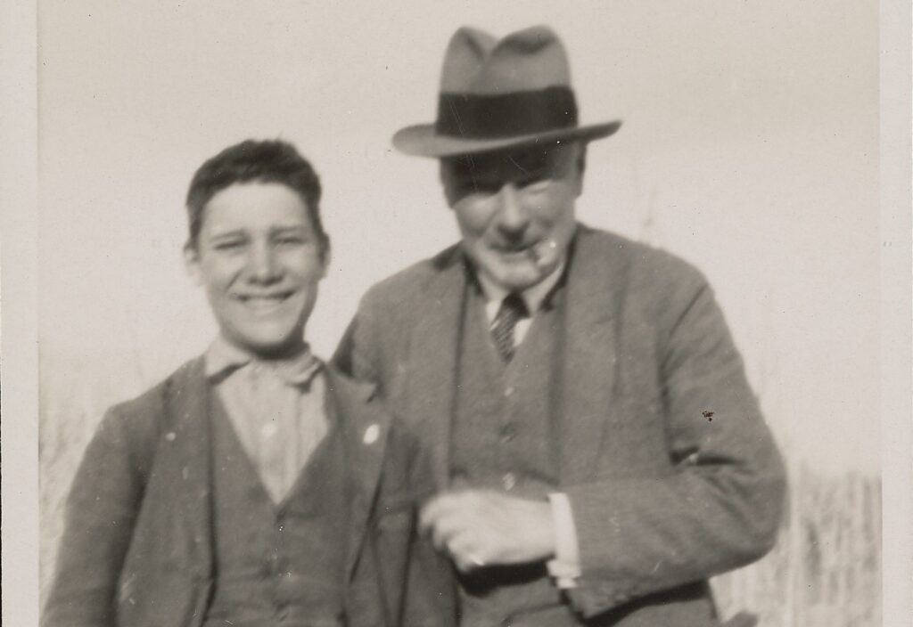 Norman Douglas standing next to boy.